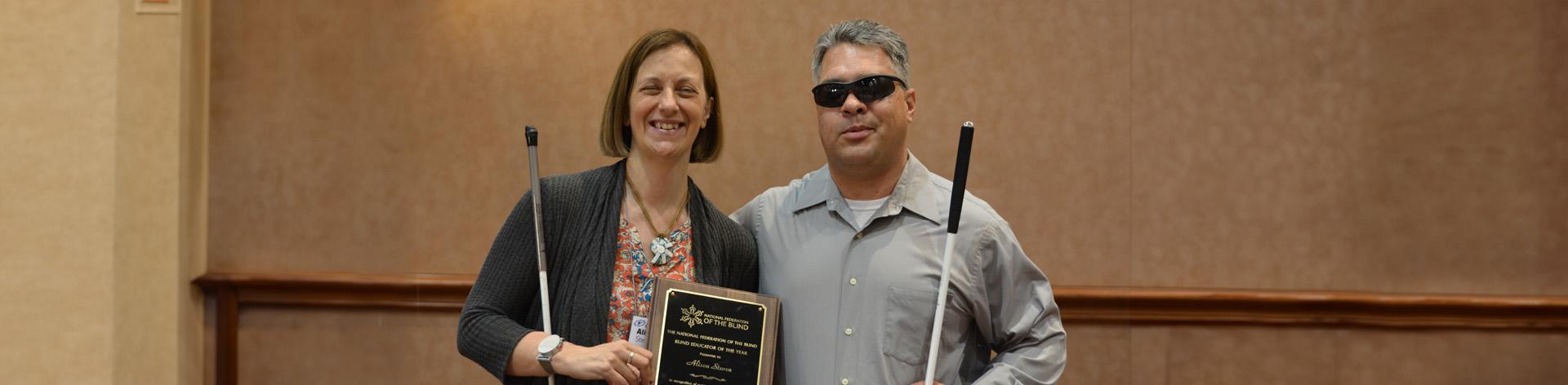 Alison Steven of Idaho winner of the Blind Educator of the Year award holding her plaque with Dr Edward Bell.